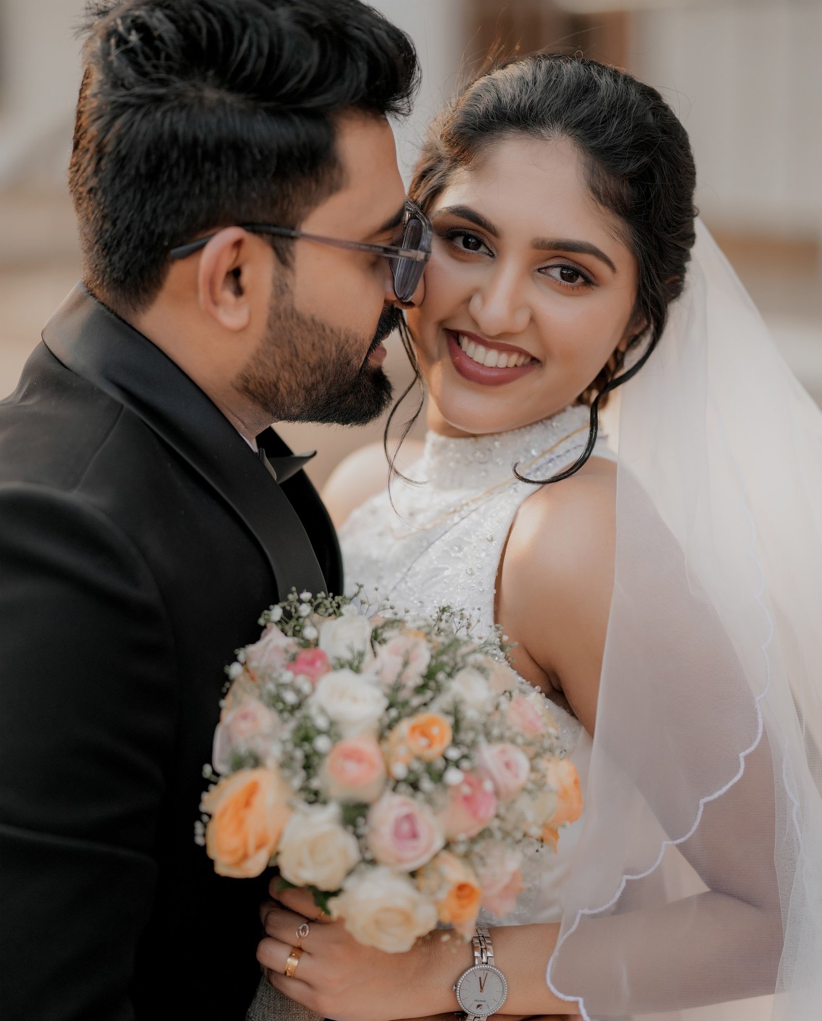 Bride smiling as the groom leans close