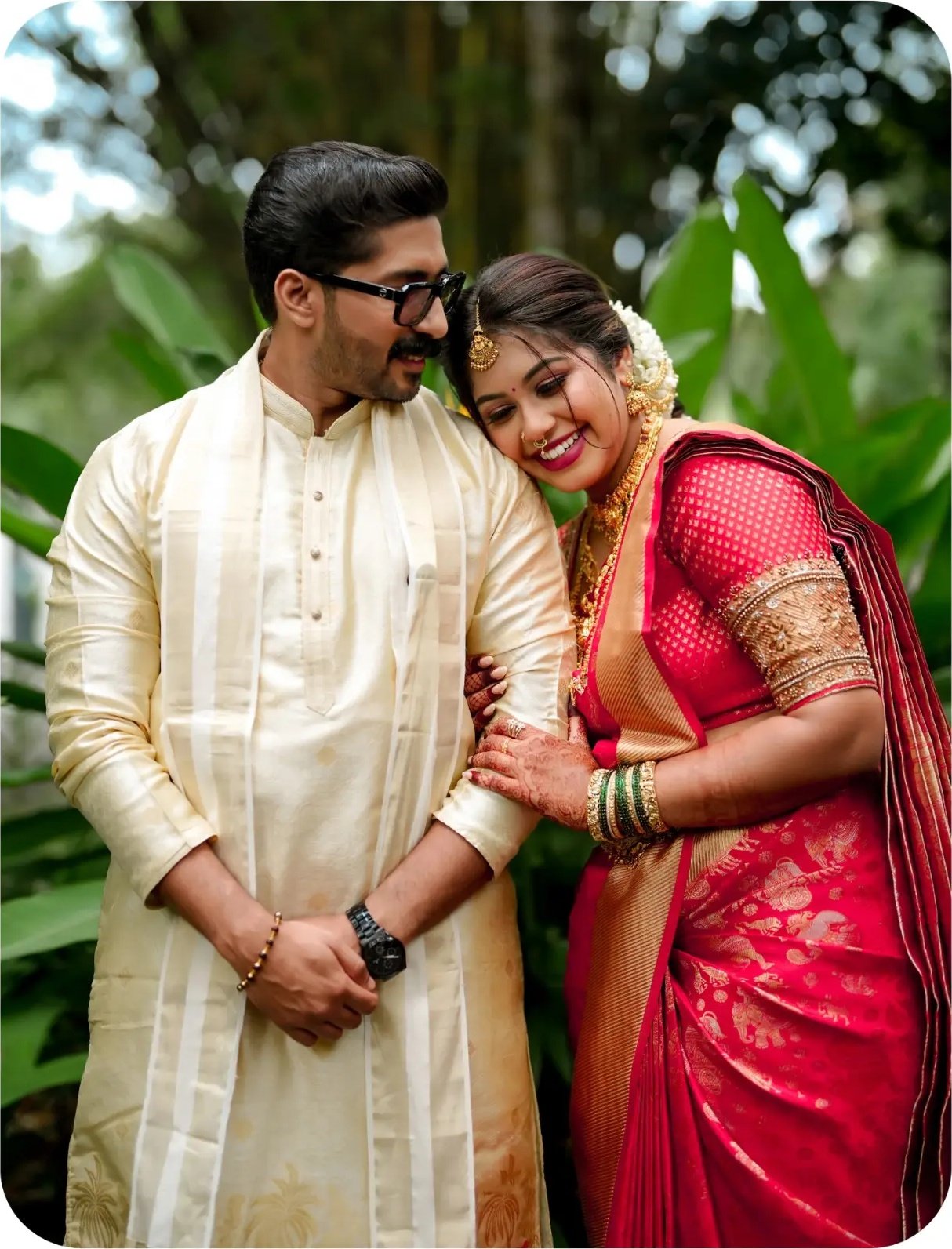 Newlyweds standing close in traditional wedding attire